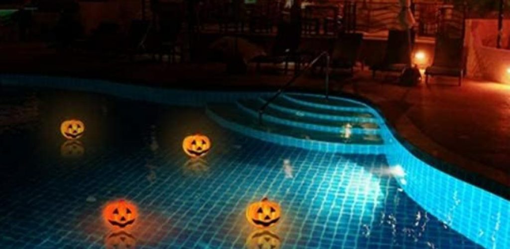 pumpkins floating in a pool