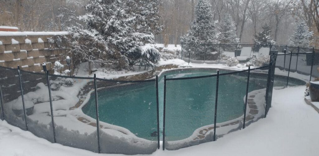 A swimming pool open during a snow storm