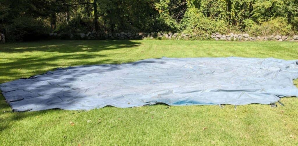 Pool cover laid out in the yard